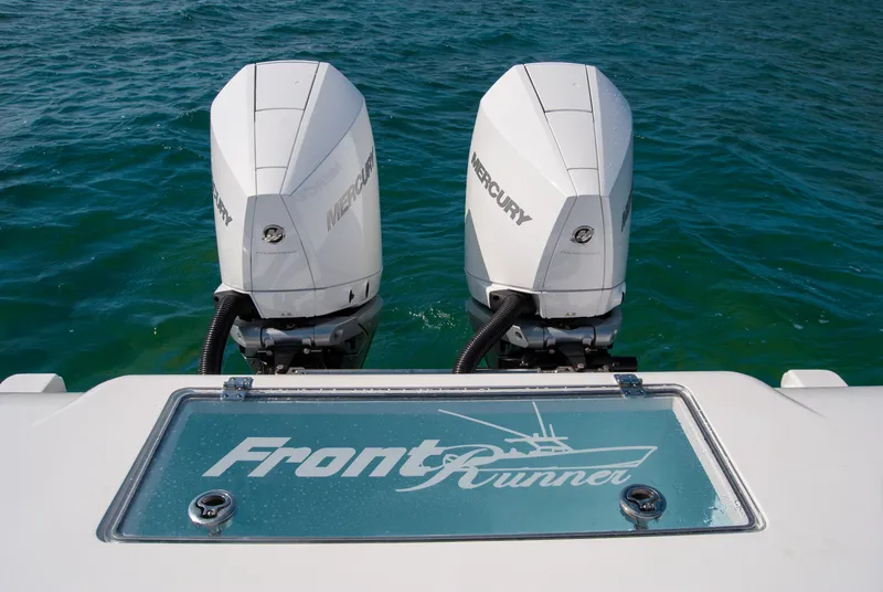 Slide: The Image of 2023 Front Runner 33 Center Console with twin Mercury outboard engines on blue water. - 14