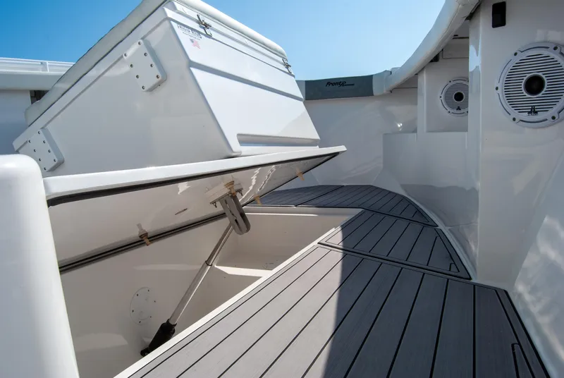 Slide: The Image of 2023 Front Runner 33 Center Console boat interior with storage compartment open. - 19