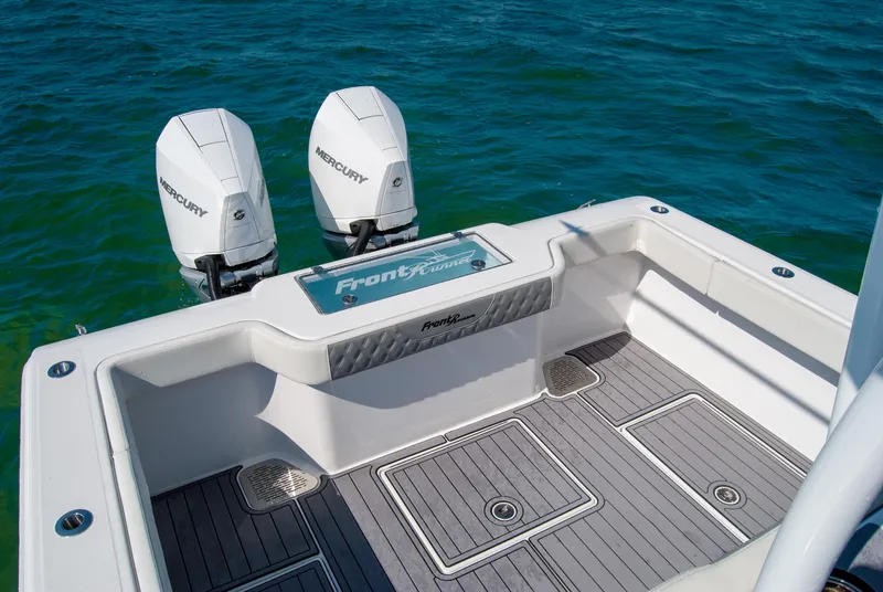 Slide: The Image of 2023 Front Runner 33 Center Console boat with twin Mercury engines on blue water. - 24