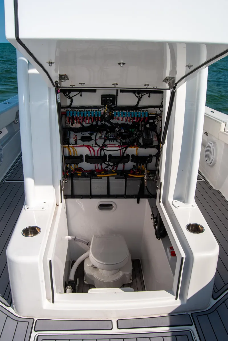 Slide: The Image of 2023 Front Runner 33 Center Console boat with open console showing wiring and marine toilet. - 27