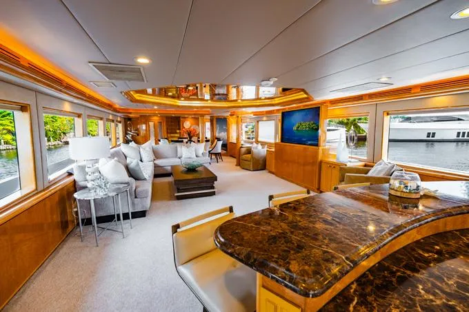 Slide: The Image of Luxurious 1995 Hatteras Motor Yacht interior with elegant seating and large windows. - 1