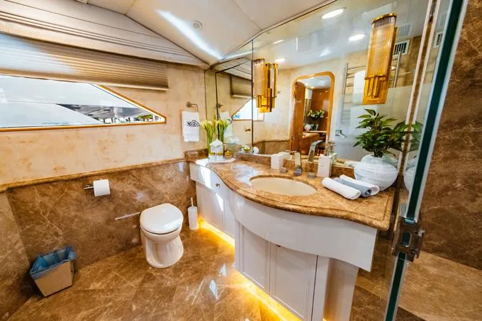 Slide: The Image of Luxurious 1995 Hatteras Motor Yacht bathroom with marble decor and elegant lighting. - 19