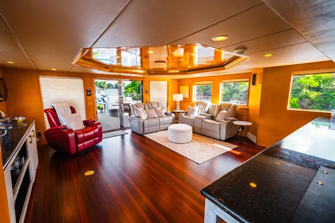 Slide: The Image of Luxurious 1995 Hatteras Motor Yacht interior with elegant seating and polished wood flooring. - 40