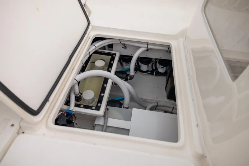 Slide: The Image of 2007 Fountain 34 Center Console boat engine compartment with visible hoses and components. - 15