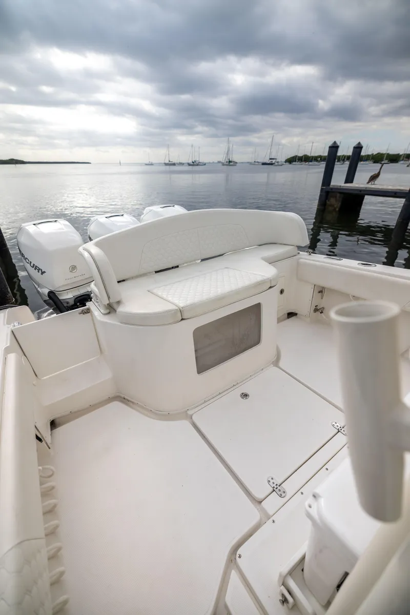 Slide: The Image of 2007 Fountain 34 Center Console boat interior with seating, docked by calm waters. - 16
