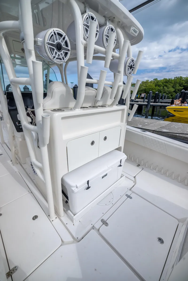 Slide: The Image of 2007 Fountain 34 Center Console boat with rod holders and storage compartments. - 18