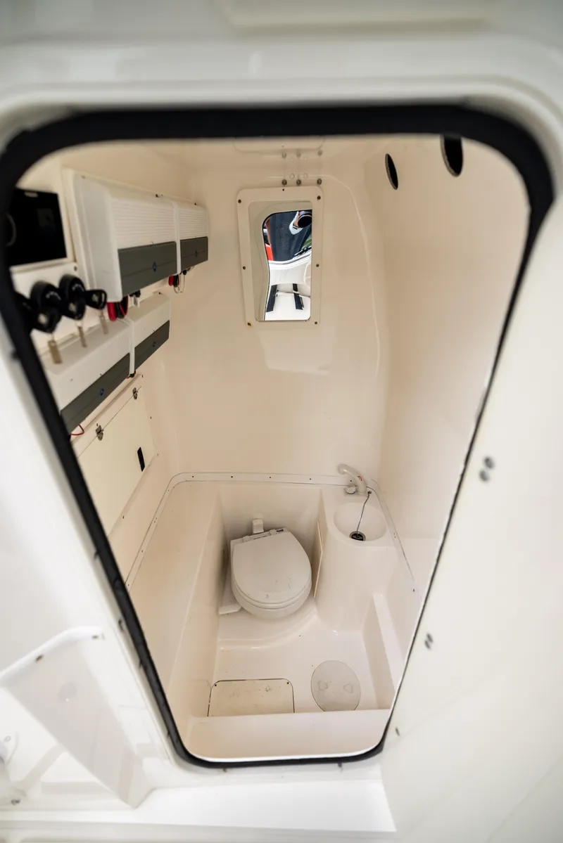Slide: The Image of 2007 Fountain 34 Center Console boat interior with compact marine toilet. - 21