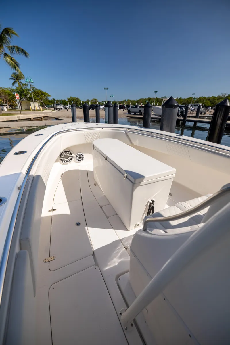 Slide: The Image of 2007 Fountain 34 Center Console boat docked at marina under clear blue sky. - 6