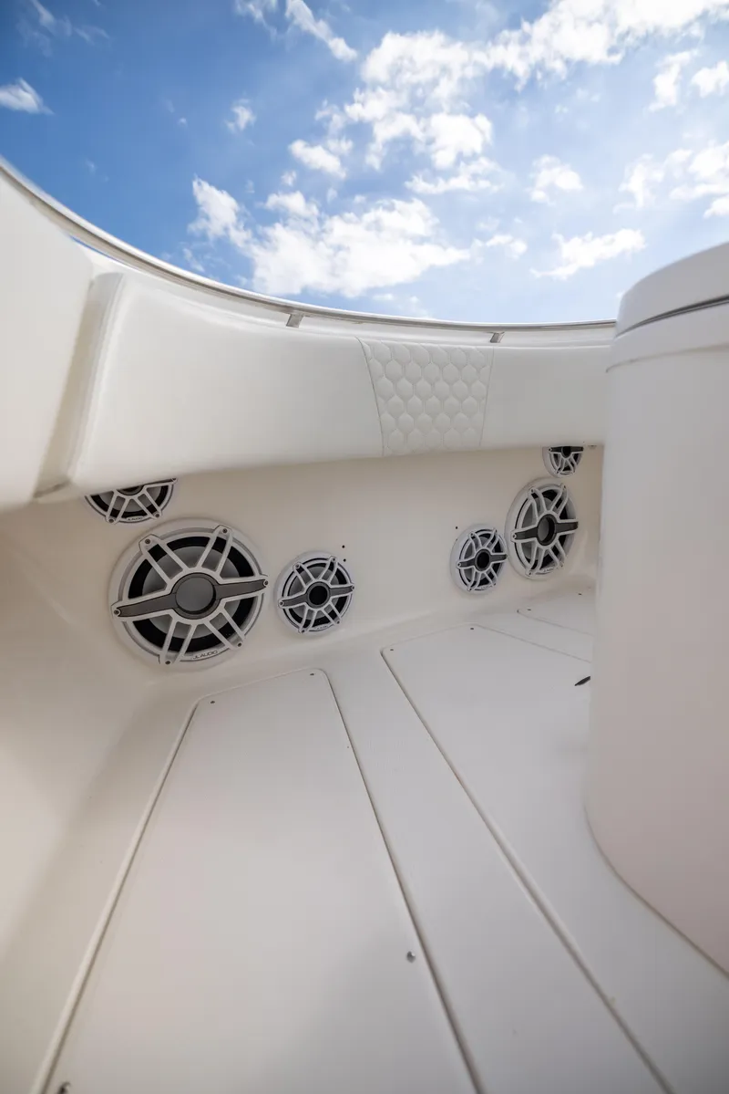 Slide: The Image of 2007 Fountain 34 Center Console boat interior with speakers and blue sky. - 9