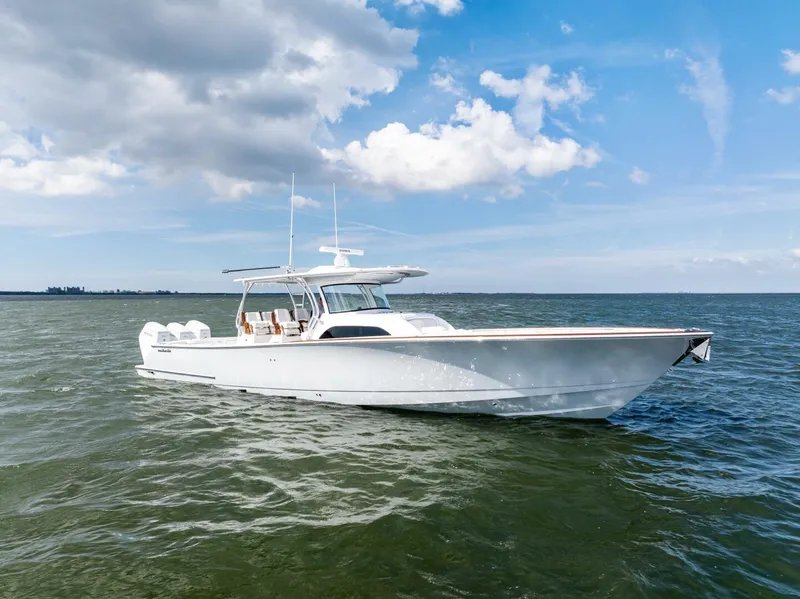 Slide: The Image of 2025 Valhalla Boatworks V-46 cruising on open water under a blue sky. - 1