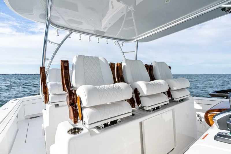 Slide: The Image of Luxurious seating on 2025 Valhalla Boatworks V-46, featuring elegant white upholstery and wooden accents. - 11