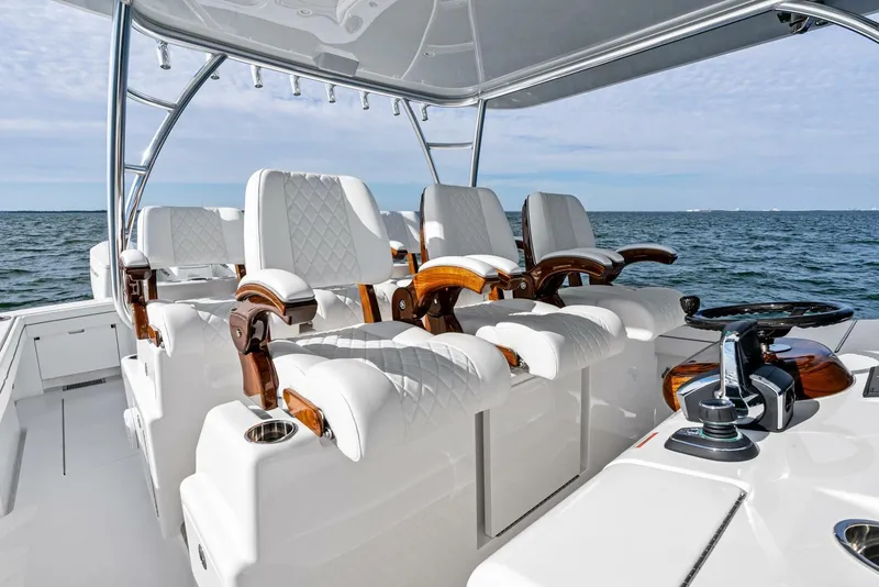 Slide: The Image of 2025 Valhalla Boatworks V-46 interior with luxurious seating and ocean backdrop. - 12