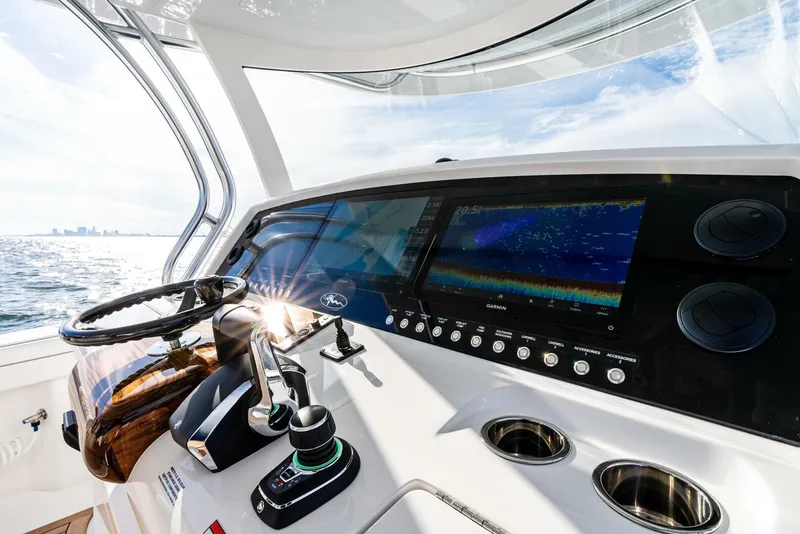 Slide: The Image of 2025 Valhalla Boatworks V-46 helm with advanced navigation system and ocean view. - 16