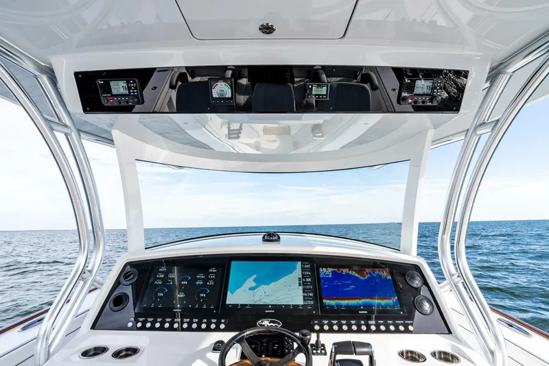 Slide: The Image of 2025 Valhalla Boatworks V-46 helm with advanced navigation displays on open sea. - 17