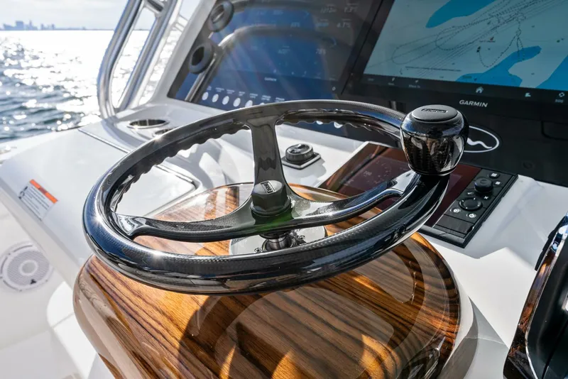 Slide: The Image of Steering wheel of 2025 Valhalla Boatworks V-46 with navigation display in sunlight. - 18