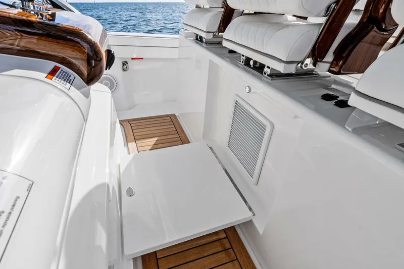 Slide: The Image of Valhalla Boatworks V-46 (2025) interior with white seating and wooden flooring. - 21