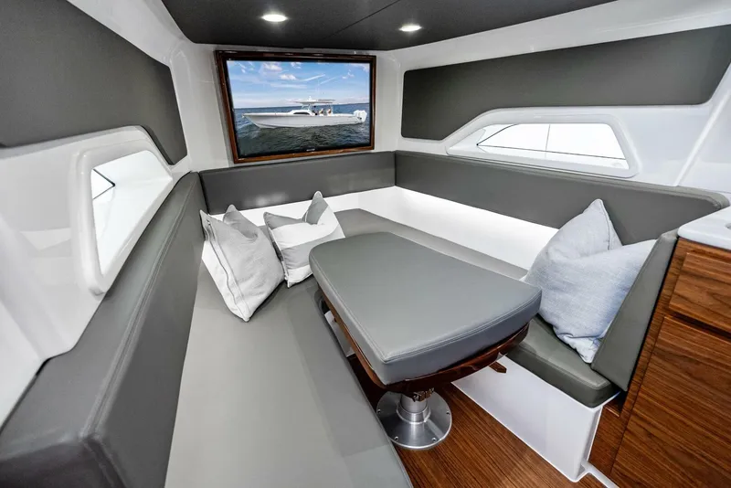 Slide: The Image of 2025 Valhalla Boatworks V-46 interior with modern seating and ocean view window. - 24