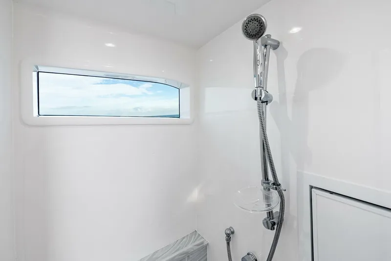 Slide: The Image of Modern shower in 2025 Valhalla Boatworks V-46, featuring sleek design and ocean view window. - 26