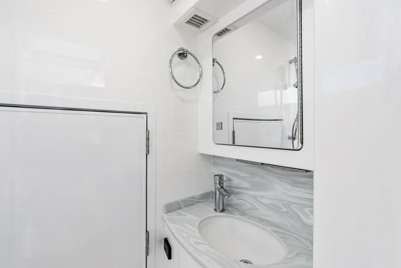 Slide: The Image of 2025 Valhalla Boatworks V-46 bathroom with modern sink and mirror design. - 27