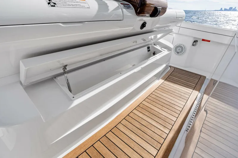 Slide: The Image of 2025 Valhalla Boatworks V-46 deck with open storage compartment and teak flooring. - 37