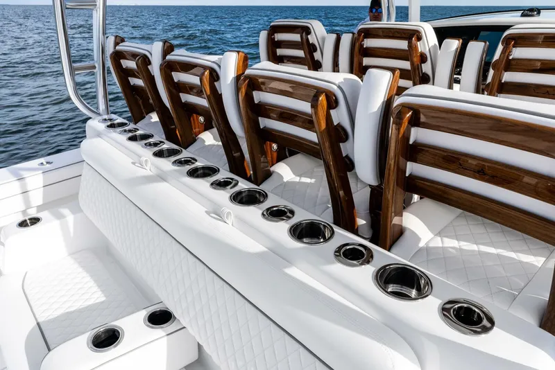 Slide: The Image of Valhalla Boatworks V-46 2025 model with luxurious seating and cup holders on open water. - 7