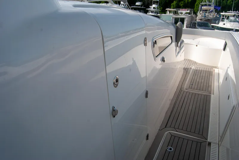 Slide: The Image of 2014 Insetta i45C boat deck with sleek white finish and wooden flooring. - 18