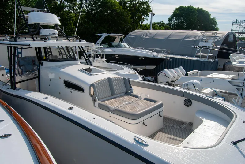 Slide: The Image of 2014 Insetta i45C boat with spacious deck and seating, docked among other vessels. - 3