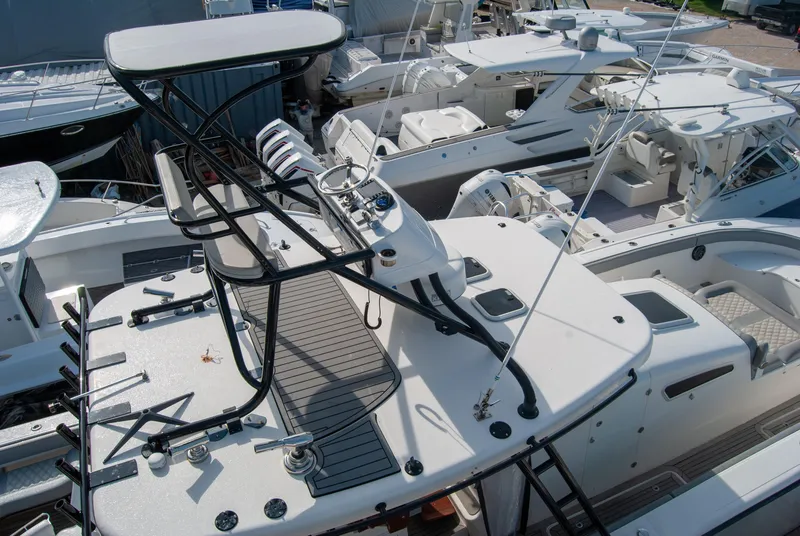 Slide: The Image of 2014 Insetta i45C boat with elevated helm, docked among other vessels. - 7