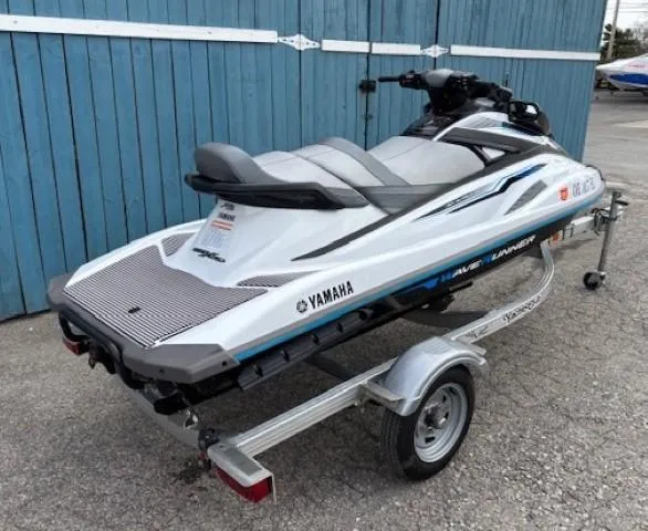 Slide: The Image of 2019 Yamaha WaveRunner VX Cruiser on trailer, parked by blue wooden fence. - 3