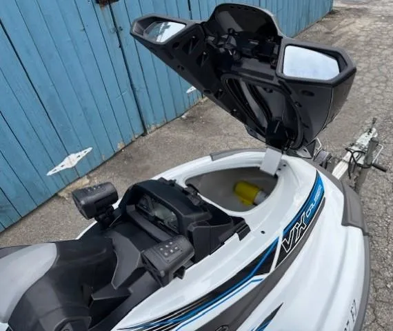 Slide: The Image of 2019 Yamaha WaveRunner VX Cruiser with open storage compartment, parked near blue garage doors. - 8