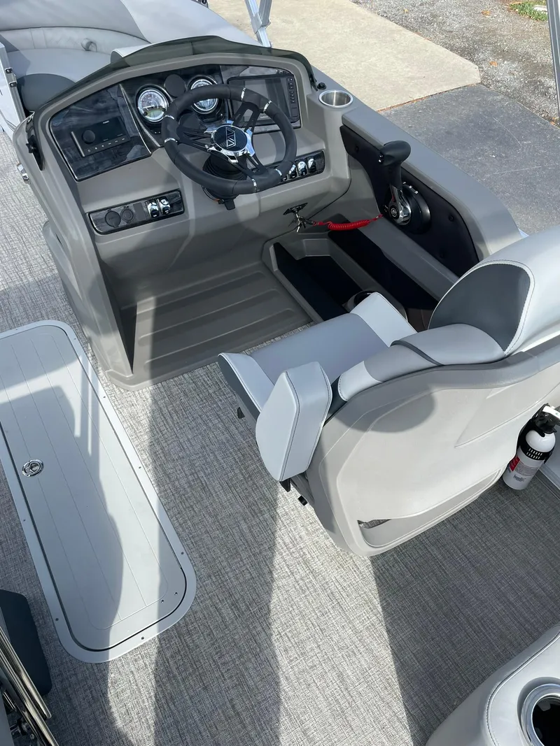 Slide: The Image of 2025 Avalon LSZ Quad Lounger Shift boat interior with steering console and seating. - 13