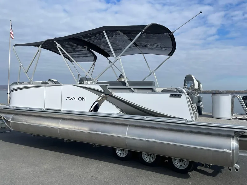 Slide: The Image of 2025 Avalon LSZ Quad Lounger Shift pontoon boat with canopy on a trailer. - 3