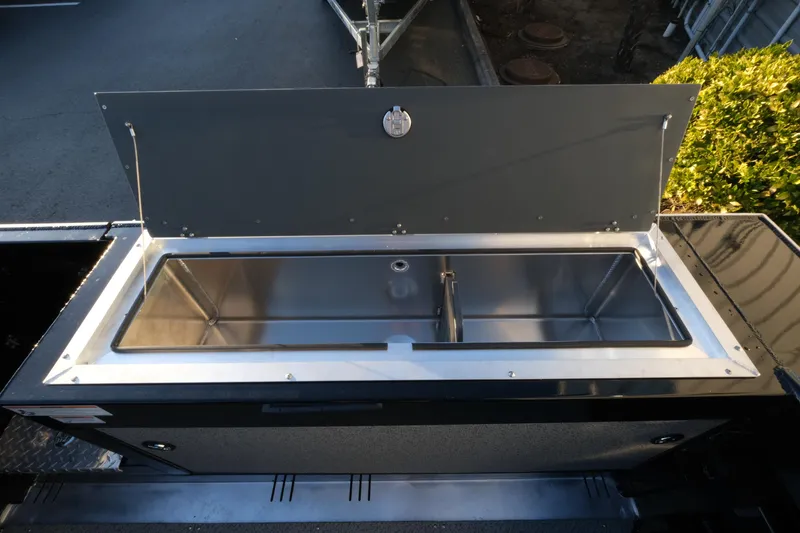 Slide: The Image of 2025 Hewescraft 220 Ocean Pro ET HT boat storage compartment open. - 10