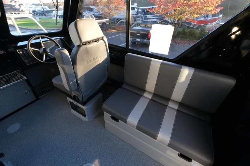 Slide: The Image of Interior of 2025 Hewescraft 220 Ocean Pro ET HT boat with seating and steering wheel. - 12