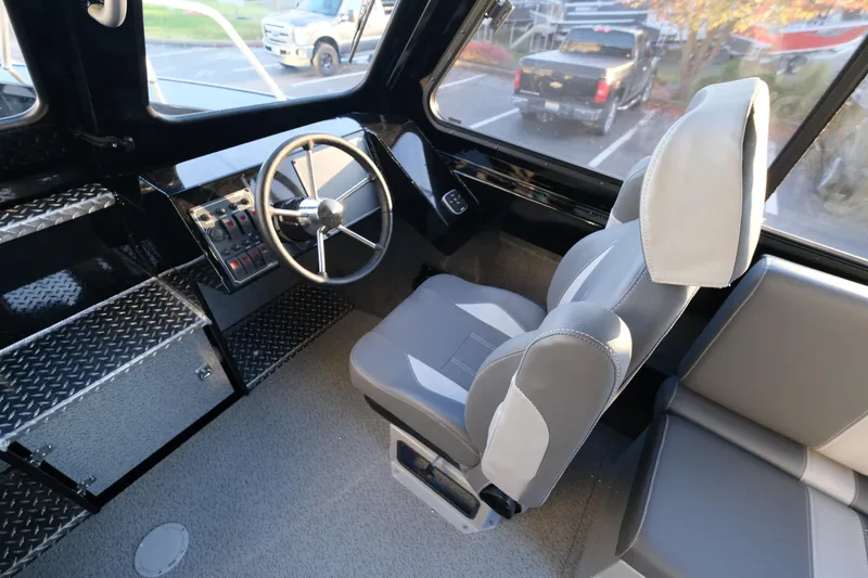 Slide: The Image of 2025 Hewescraft 220 Ocean Pro ET HT boat interior with steering wheel and seating. - 15