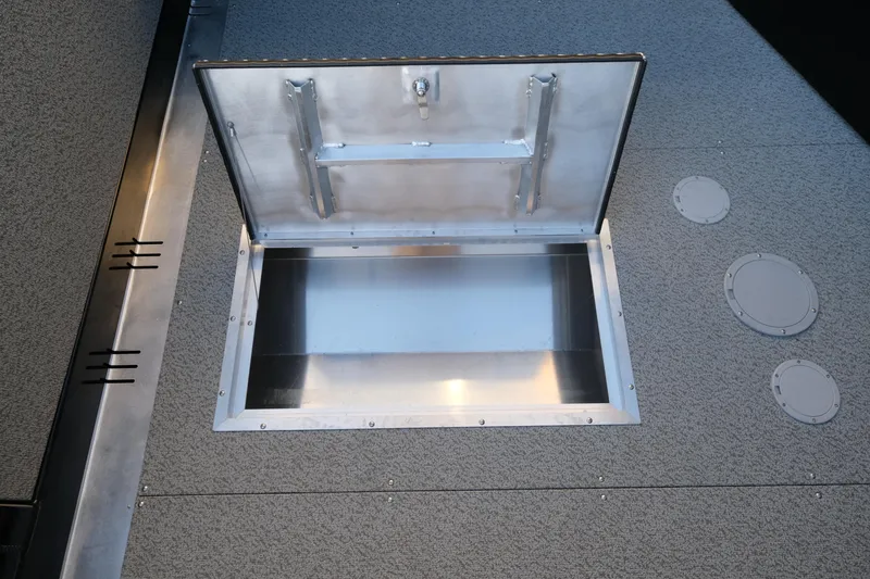 Slide: The Image of Hewescraft 220 Ocean Pro ET HT 2025 boat storage compartment, open hatch view. - 19