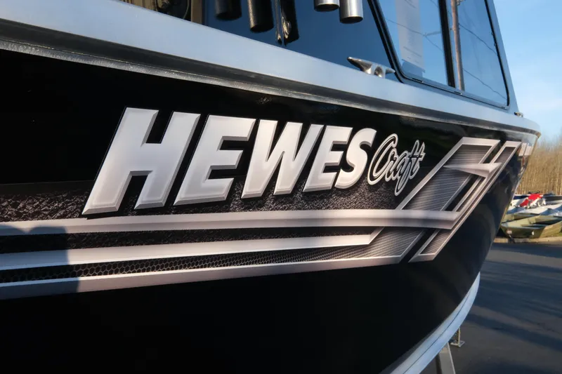 Slide: The Image of 2025 Hewescraft 220 Ocean Pro ET HT boat logo close-up. - 21