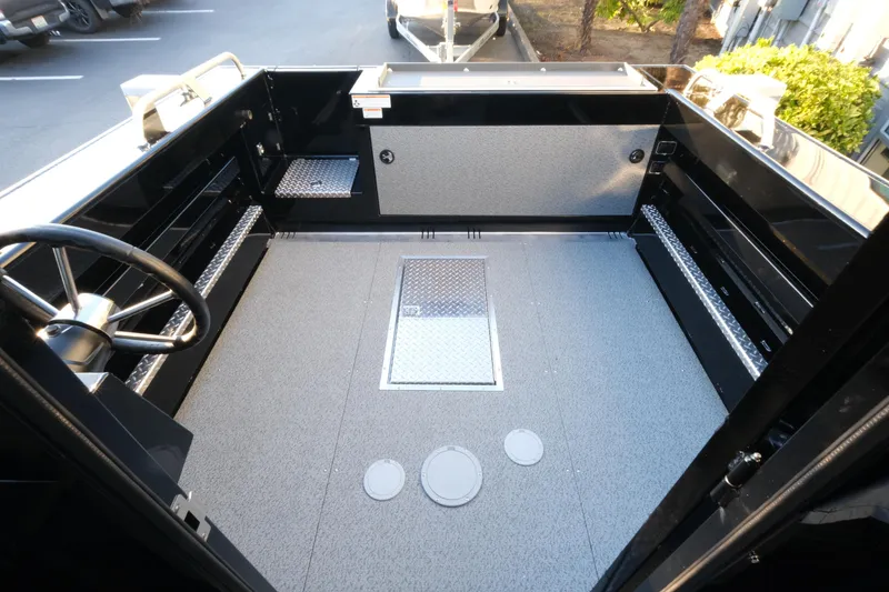 Slide: The Image of Interior view of 2025 Hewescraft 220 Ocean Pro ET HT boat, featuring spacious deck area. - 9