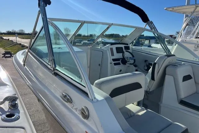 Slide: The Image of 2021 Sailfish 245 DC boat interior with steering wheel and seating. - 12