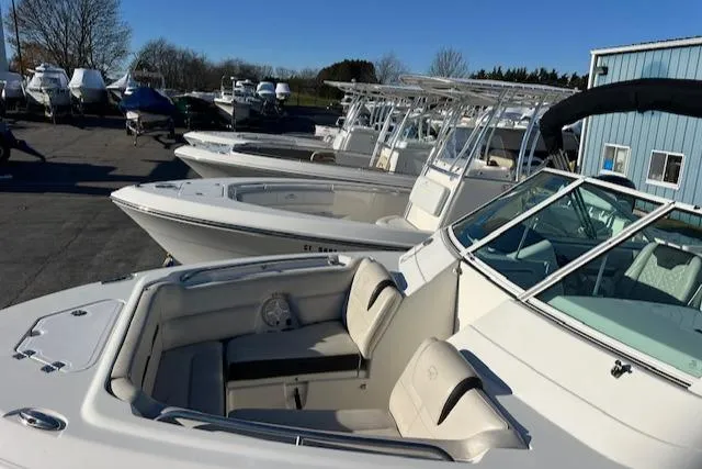 Slide: The Image of 2021 Sailfish 245 DC boat in a marina, surrounded by other boats. - 13