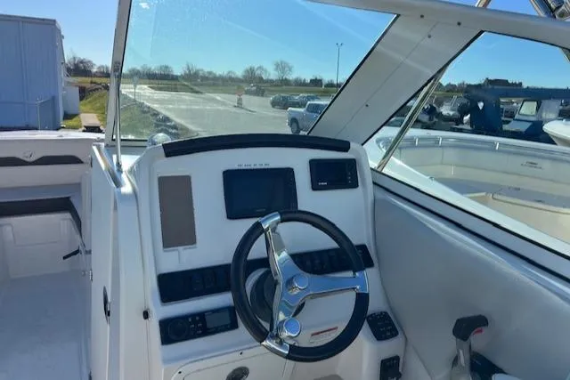 Slide: The Image of 2021 Sailfish 245 DC boat helm with steering wheel and control panel. - 4