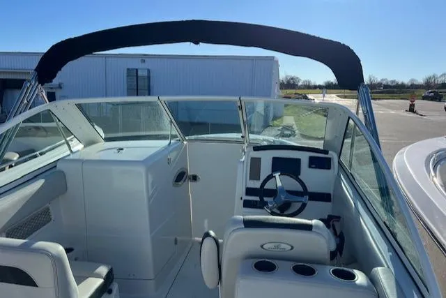 Slide: The Image of 2021 Sailfish 245 DC boat interior with steering wheel and seating. - 9