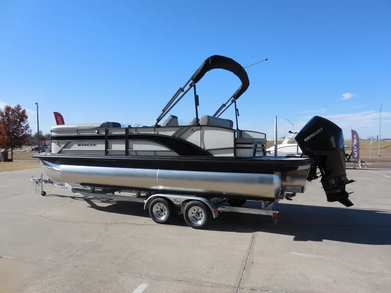 Slide: The Image of 2025 Bennington 23 SSB pontoon boat on trailer, parked outdoors. - 4