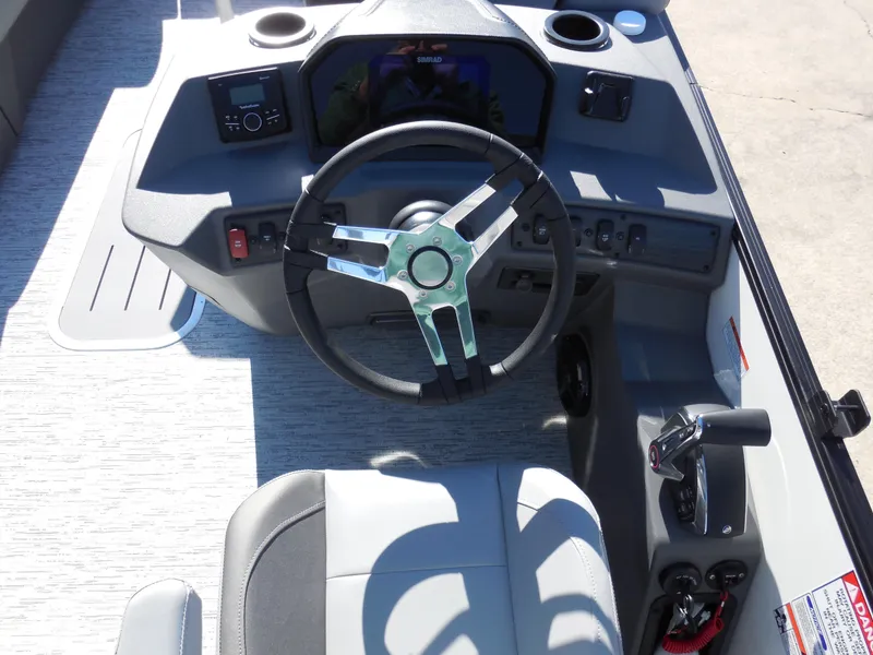 Slide: The Image of 2025 Bennington 23 SSB boat dashboard with steering wheel and controls. - 7