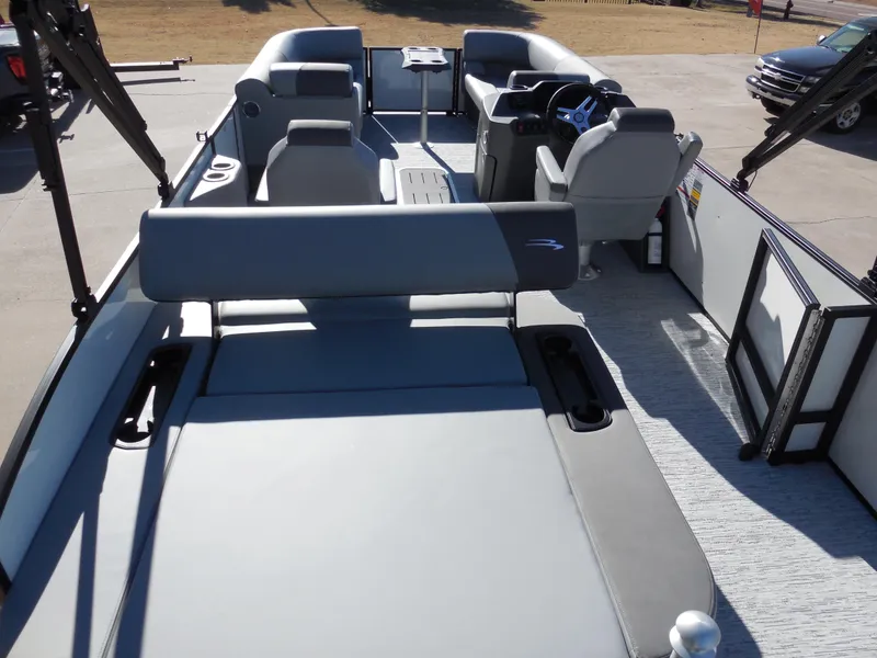 Slide: The Image of 2025 Bennington 23 SSB pontoon boat interior with gray seating and modern dashboard. - 9