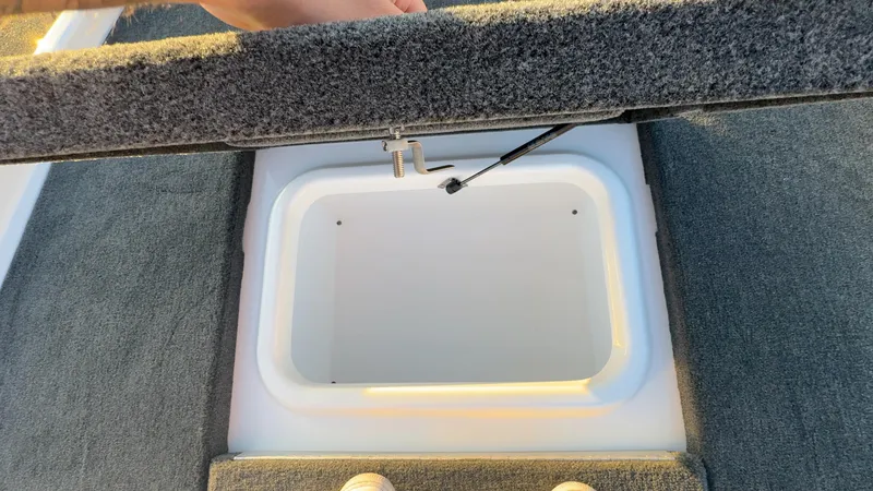 Slide: The Image of Open storage compartment on 2025 Skeeter ZX150 boat deck. - 13