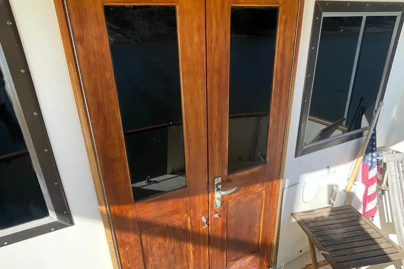 Slide: The Image of Wooden doors on 1984 Hatteras 53 Extended Deckhouse Motor Yacht with American flag. - 15
