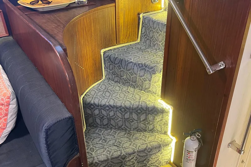 Slide: The Image of Interior stairs of 1984 Hatteras 53 Motor Yacht with patterned carpet and ambient lighting. - 17