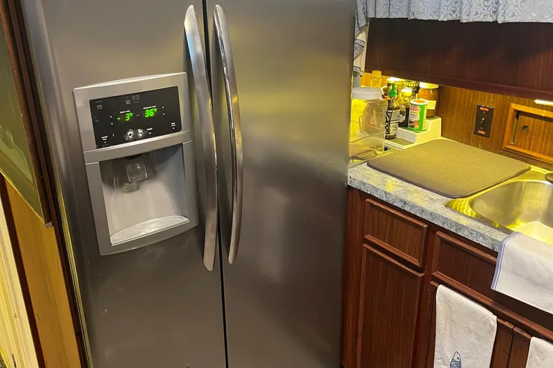 Slide: The Image of Kitchen area of 1984 Hatteras 53 Motor Yacht with stainless steel refrigerator. - 19