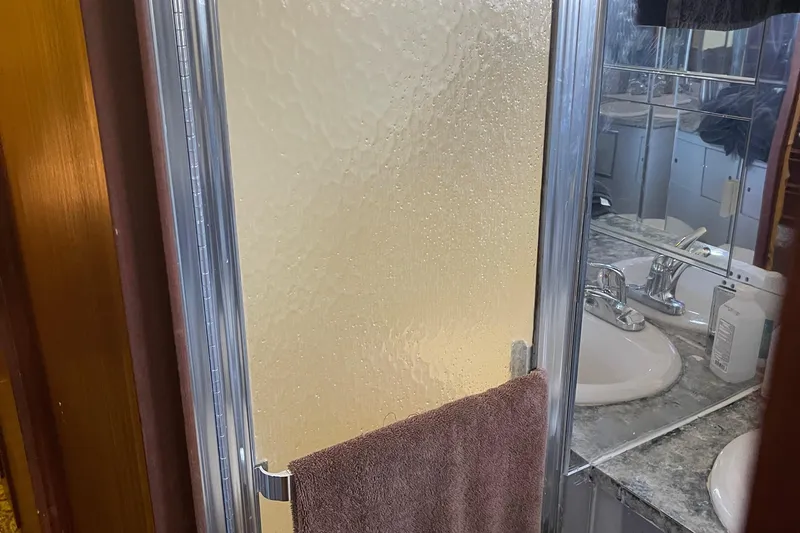 Slide: The Image of Bathroom with frosted glass shower door on 1984 Hatteras 53 Motor Yacht. - 33